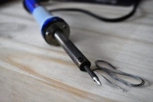 soldering iron with tin on the end of its tip