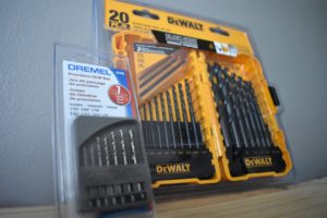 dewalt drill bits laying next to dremel drill bits