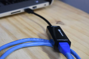 USB-to-Ethernet converter connected to a computer to add an extra ethernet port