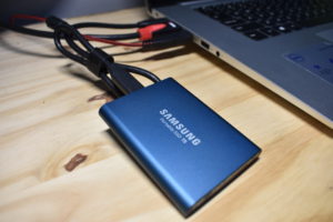 External solid state drive plugged into a computer via USB